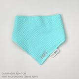 Custom baby bib in mint with embroidered name, personalised baby gift made from breathable muslin by TinyBitz.