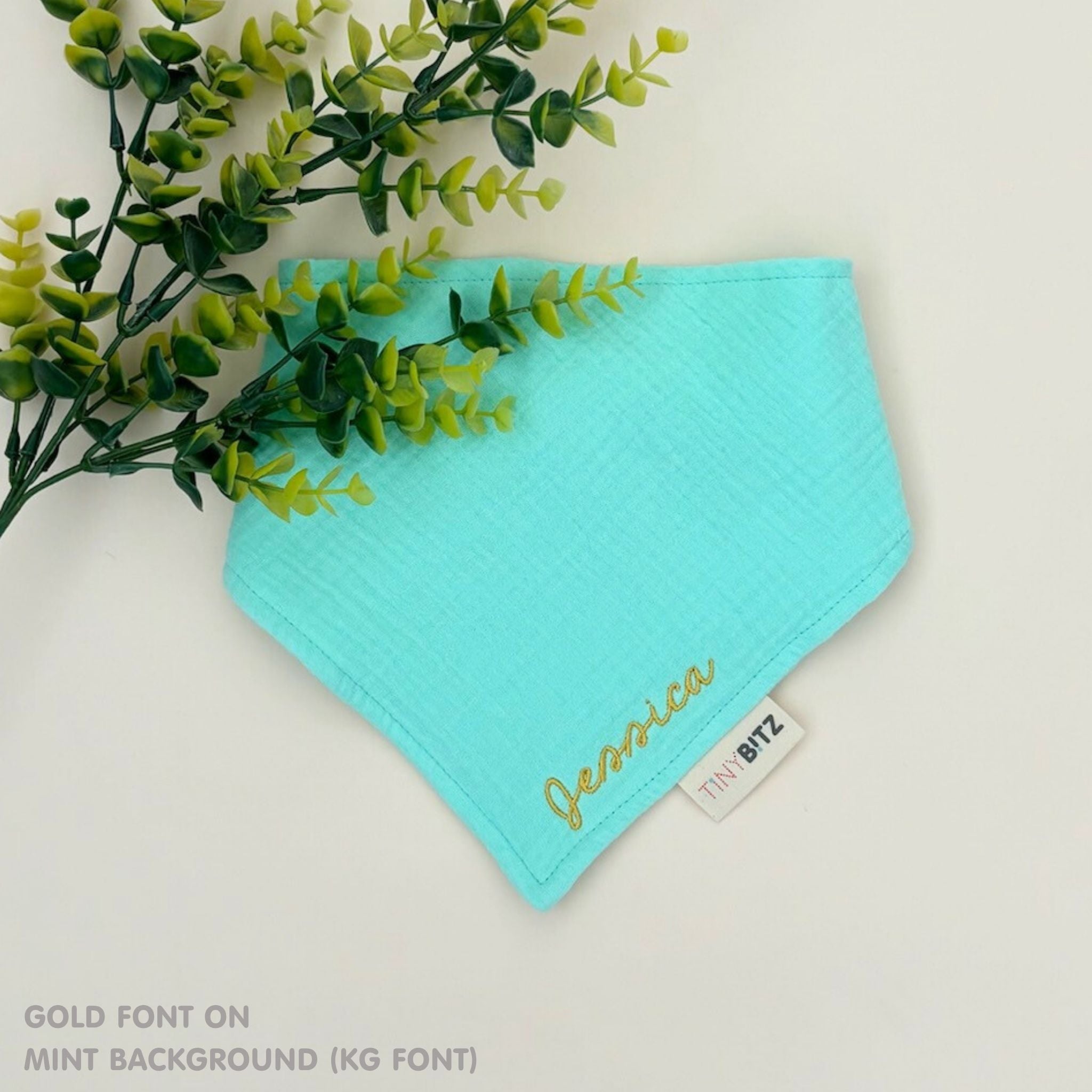 Neutral-toned personalised baby bib with minimalist name embroidery, custom made to order newborn gift by TinyBitz.