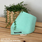 Personalized mint organic muslin bib with custom name embroidery, perfect for baby gifts and keepsake accessories.
