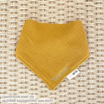 Organic cotton baby bib with name stitched on mustard fabric, personalised baby gifts by TinyBitz.