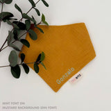 Organic cotton baby bib with name stitched on mustard fabric, personalised baby gifts by TinyBitz.