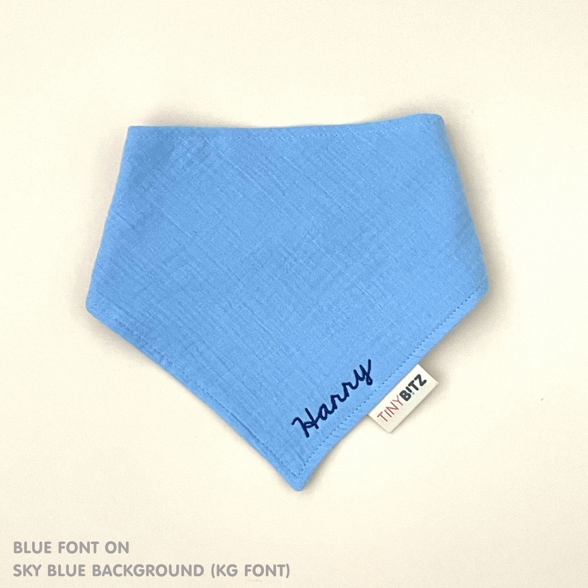 Organic personalised bib for babies in sky blue, featuring baby name in script font, unique baby gift idea by TinyBitz.