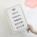 Font options for name personalization on TinyBitz personalized coral pink organic muslin baby bib.
