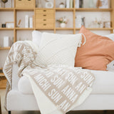 Custom knitted blanket with family members' names on it, making it the best personalised family gift!