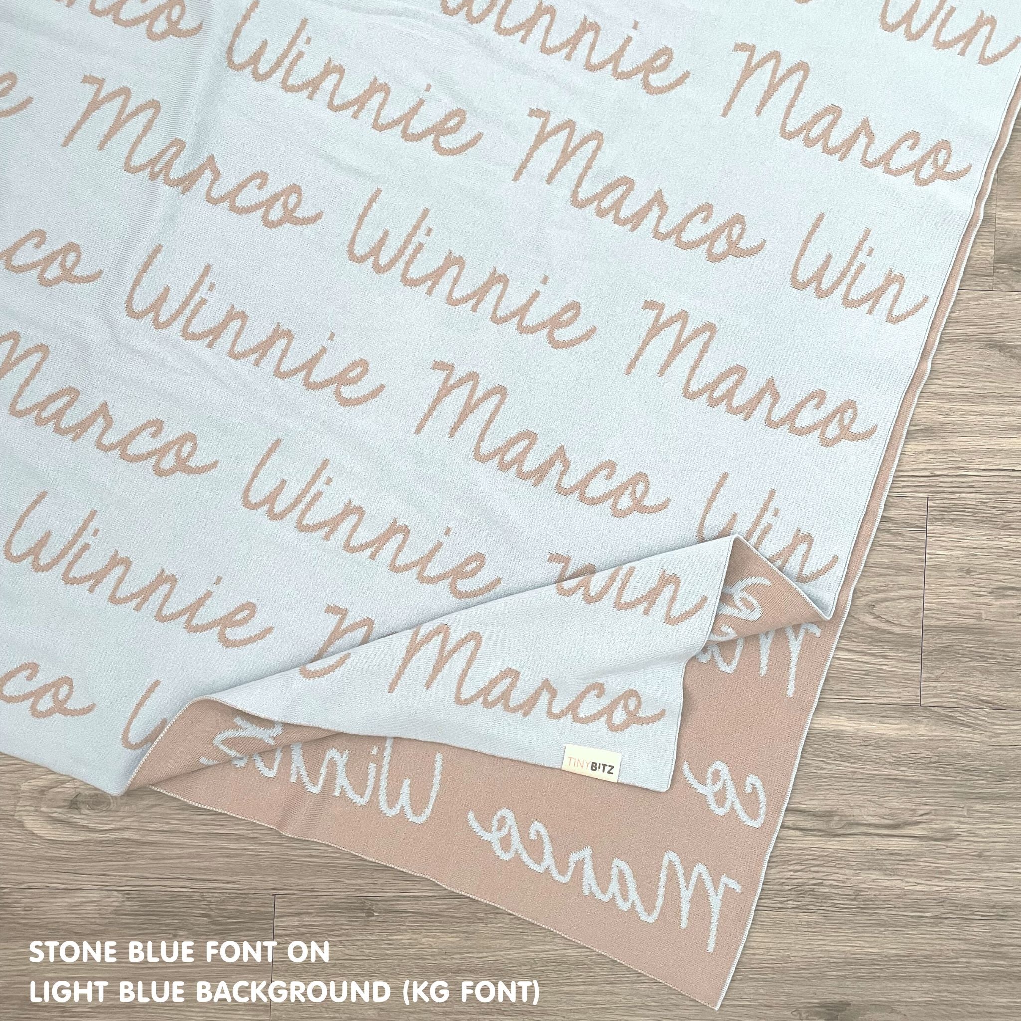 TinyBitz custom name blanket with couple's name knitted in light blue and stone, making the perfect wedding or anniversary gift!