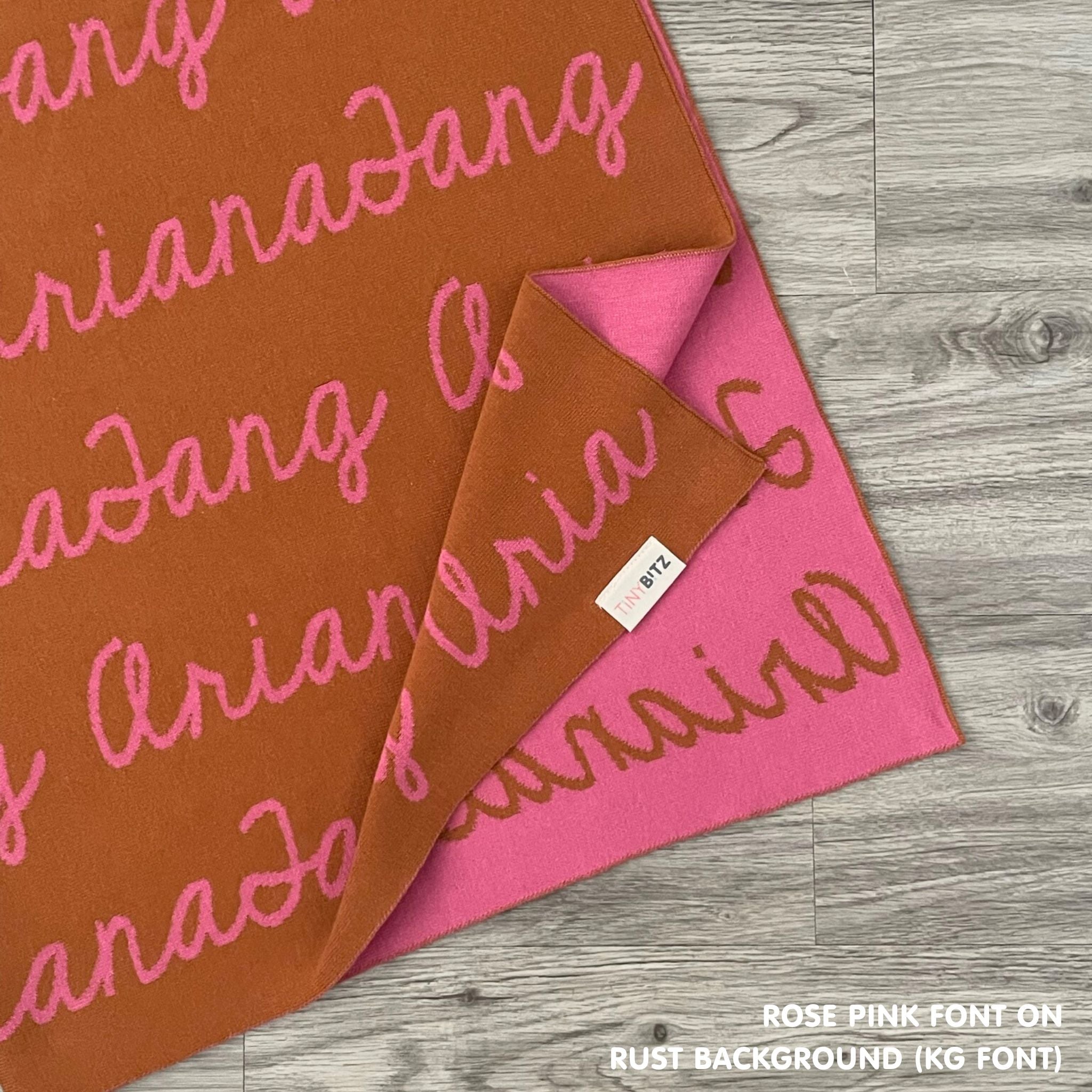 TinyBitz Personalized baby knitted name blanket in rust and rose pink, making the best baby shower gift!