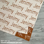 Cotton baby blanket with baby's name knitted in oatmeal and rust, made by TinyBitz.