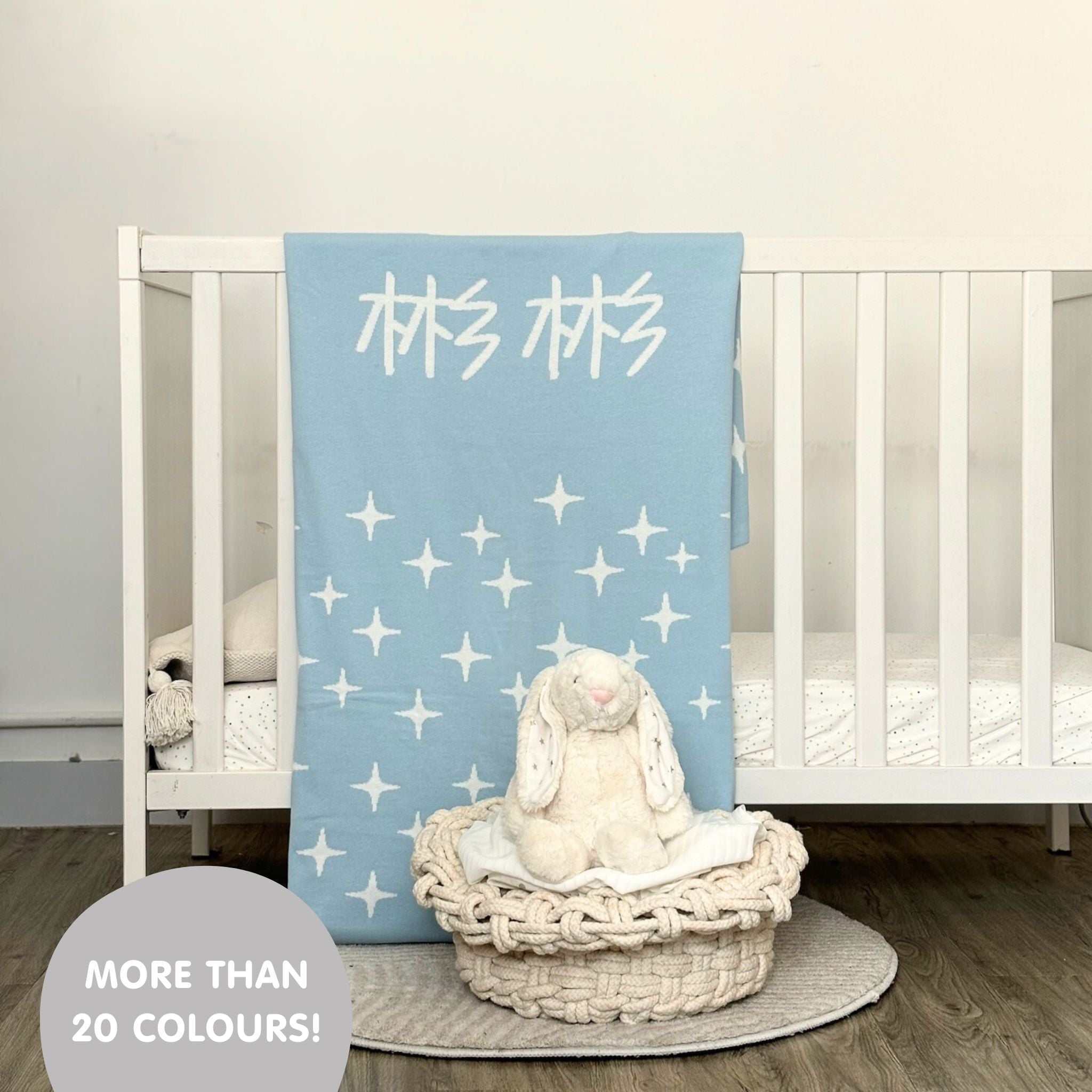 Knitted baby blanket in light blue and white with a twinkles pattern, customised with baby's name, made by TinyBitz.