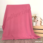 Cotton baby blanket with baby's name knitted in rose pink background, made by TinyBitz.