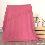 Cotton baby blanket with baby's name knitted in rose pink background, made by TinyBitz.