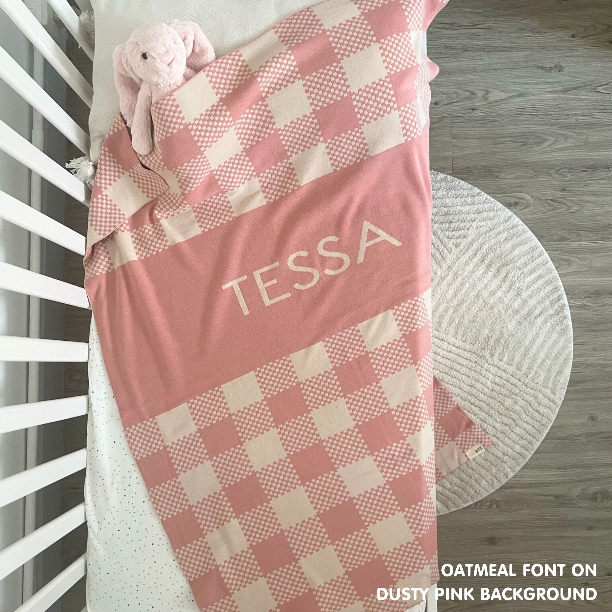 Cotton baby blanket with baby's name, knitted in dusty pink and oatmeal with a check pattern, made by TinyBitz.