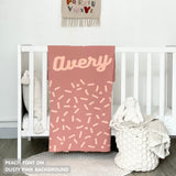 TinyBitz personalized baby name blanket, knitted in dusty pink and peach with a confetti pattern, perfect baby shower gift!