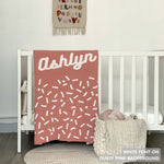 TinyBitz personalized baby knitted name blanket in dusty pink and white, perfect gift for birthdays and special occasions!