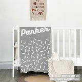 TinyBitz personalized name blanket in light grey and whitel with a confetti pattern, perfect gift for newborn babies and kids.
