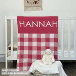 Knitted baby blanket in rose pink and white with a check pattern, customised with baby's name, made by TinyBitz.