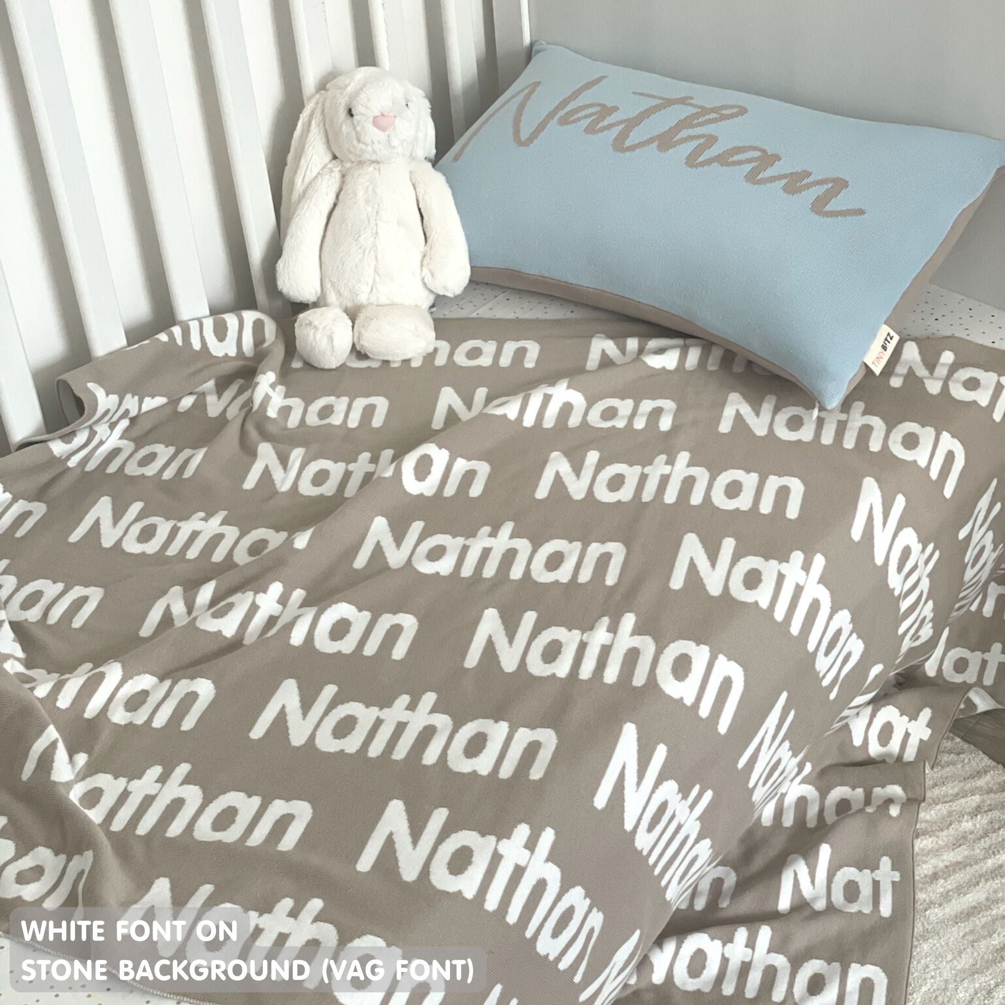TinyBitz personalized knitted blanket in stone background, customized with baby's name and made from 100% cotton.