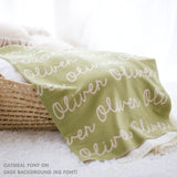 TinyBitz personalized knitted blanket in sage background, customized with baby's name and made from 100% cotton.