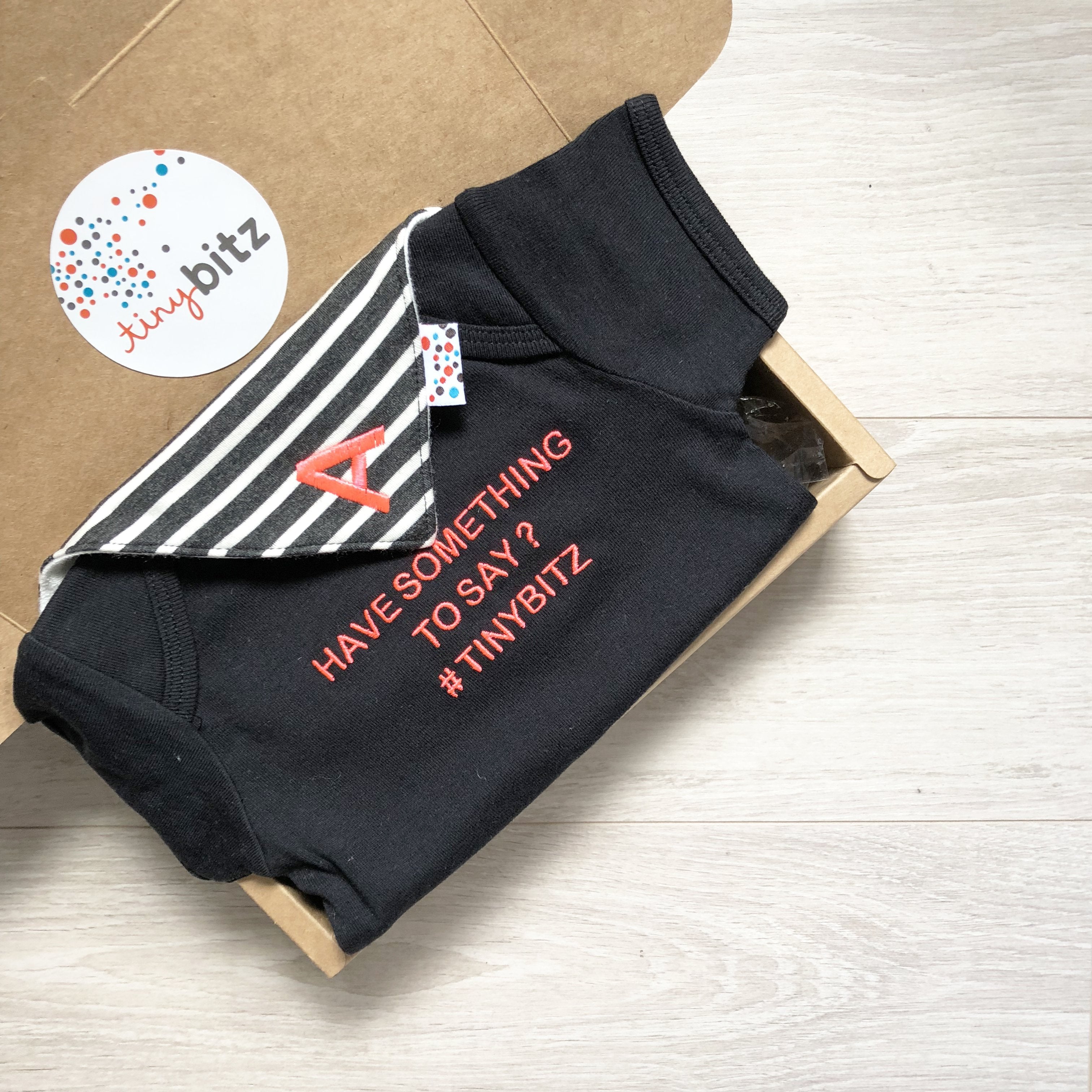 Personalised baby onesie with “Customise Your Saying” in black — custom newborn gift by TinyBitz